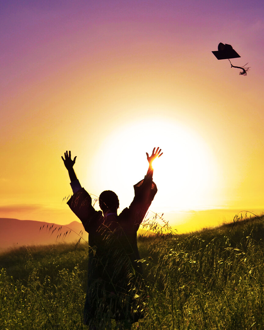 senior portraits throwing cap sunset
